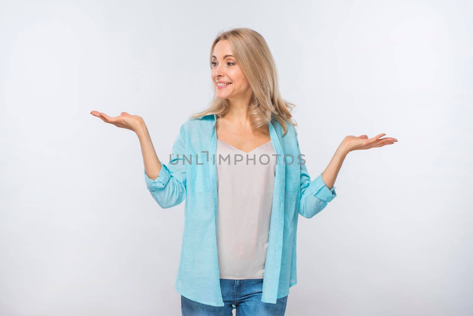smiling young woman shrugging isolated against white background by Zahard