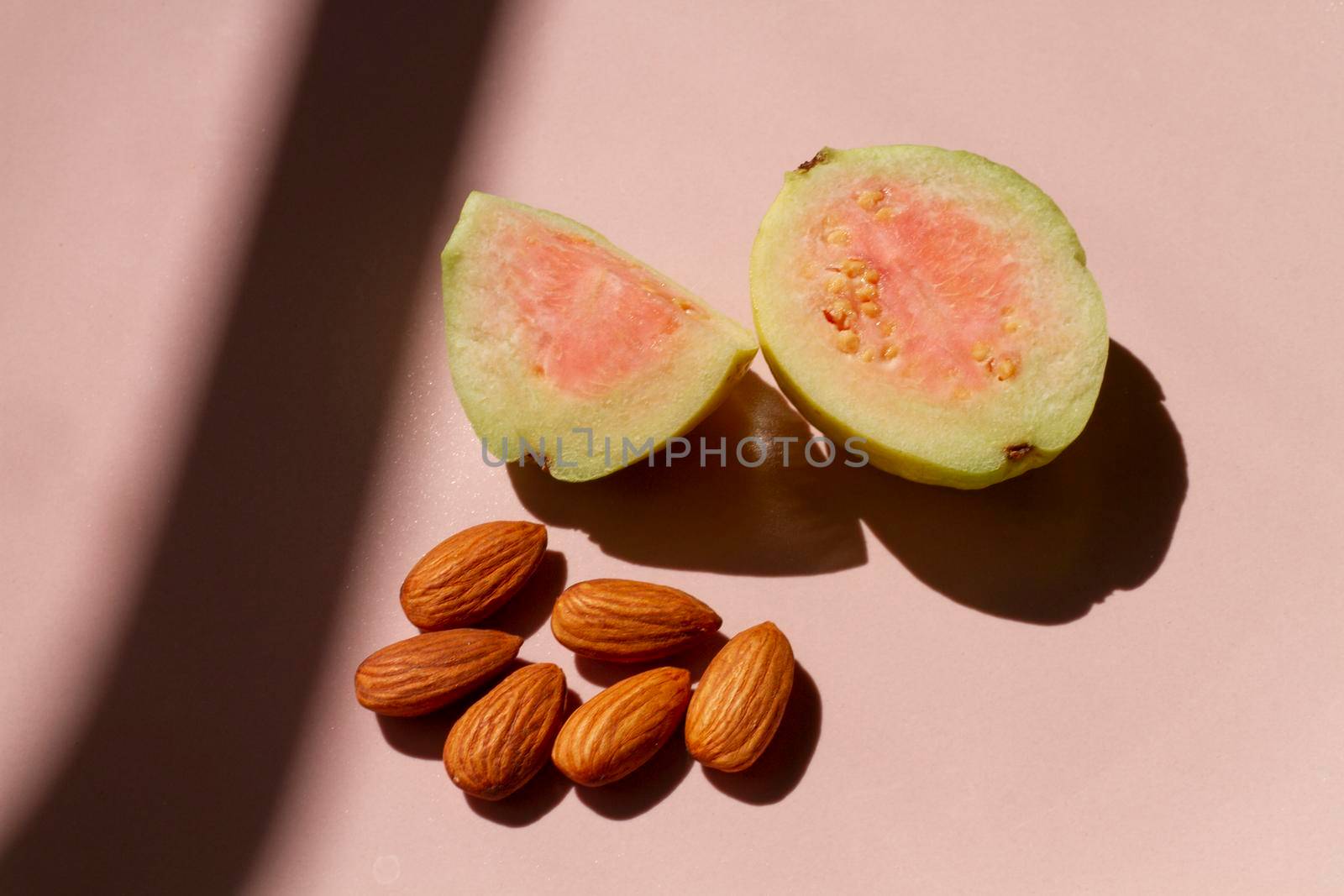 cut guava fruit with almonds by Zahard