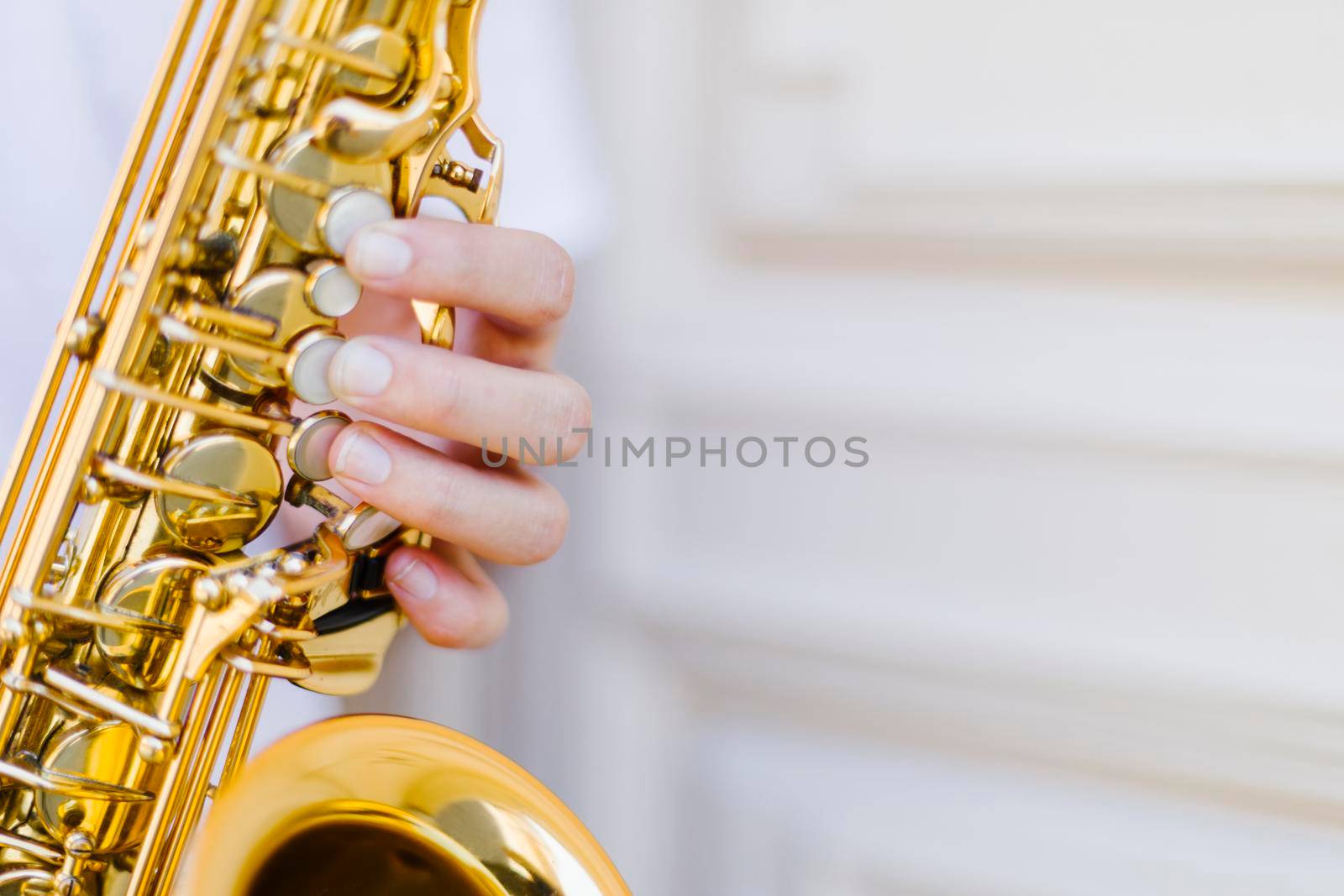 close up held saxophone with blurred background by Zahard