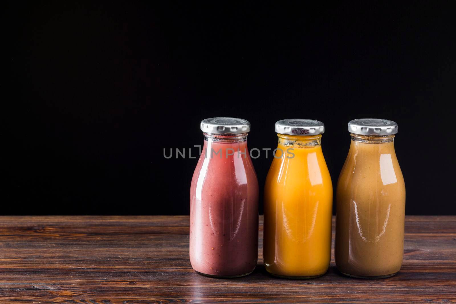 smoothie bottles wooden surface by Zahard