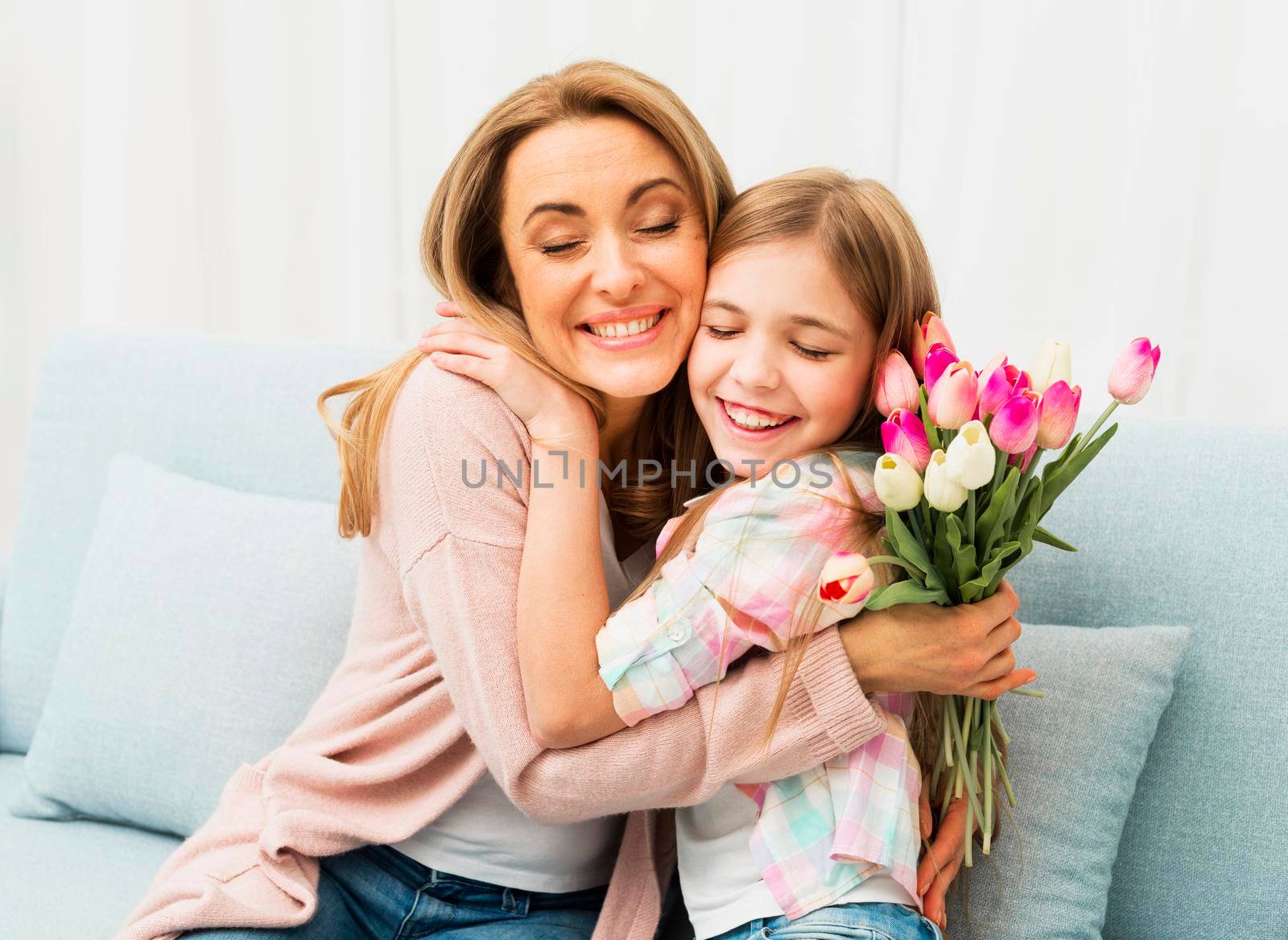 mom daughter with satisfied face hugging each other