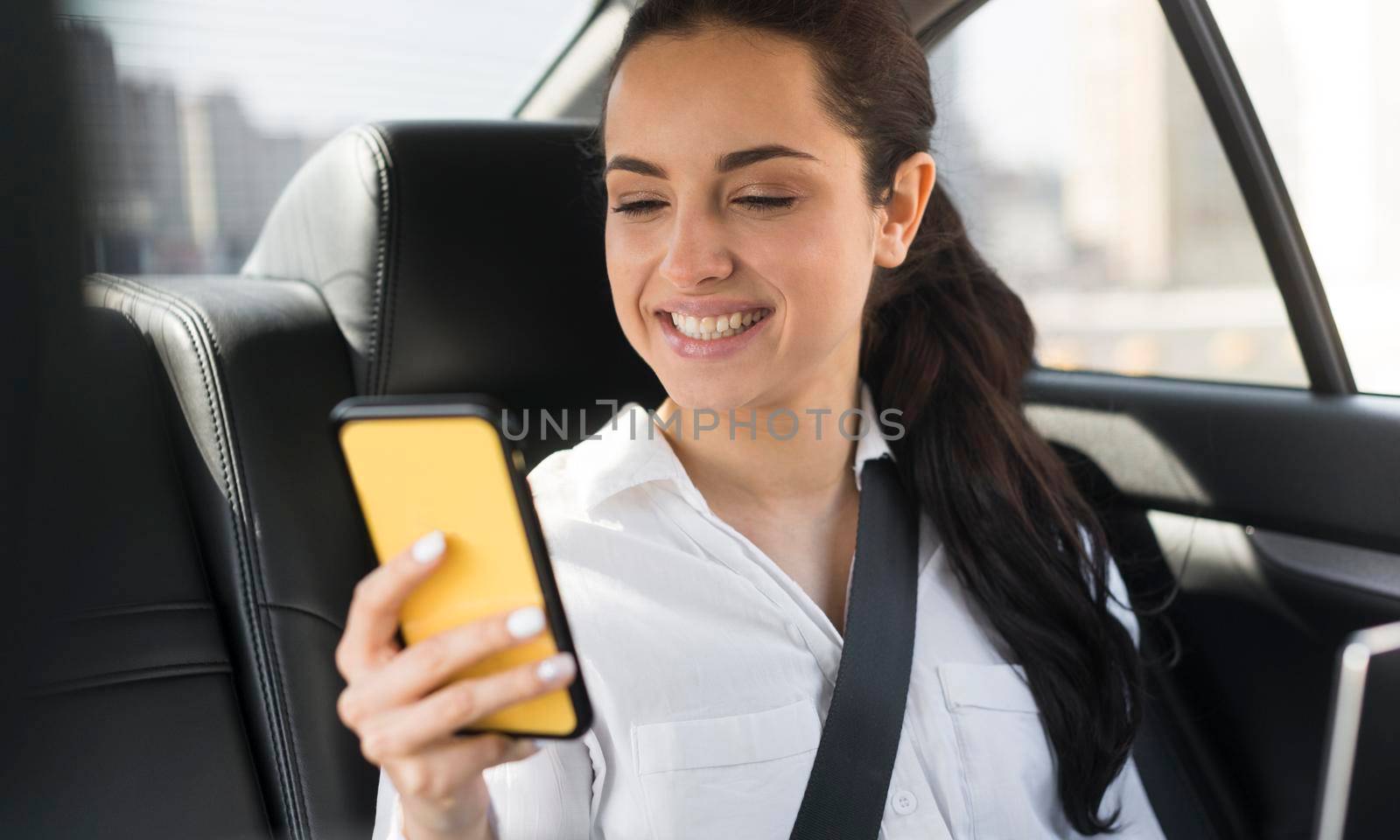 passenger using her mobile phone car