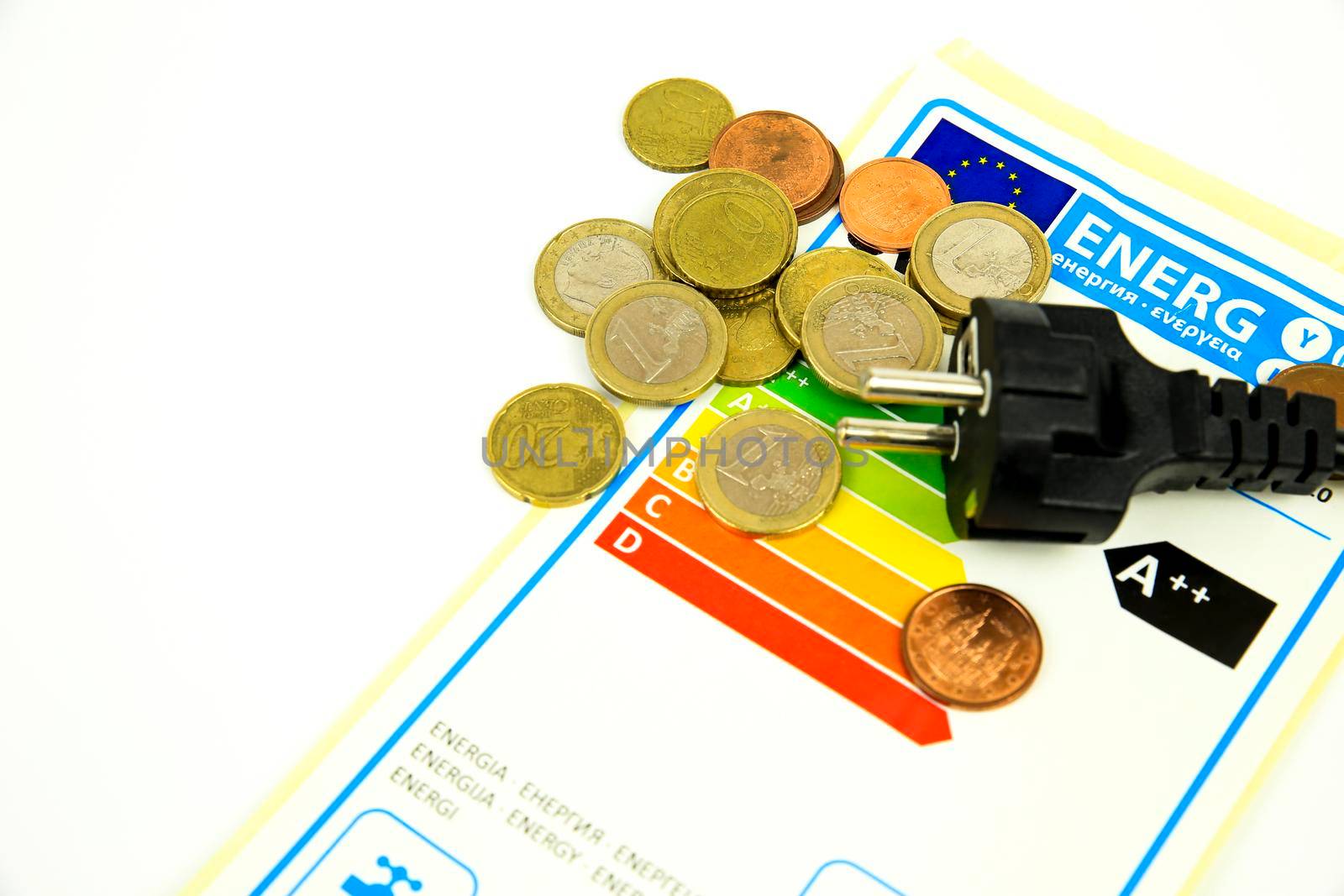 European Union Energy Label next to black pin power plug and coins