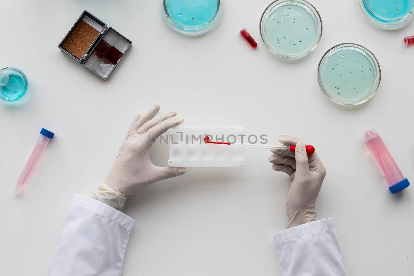 close up scientist holding pipette