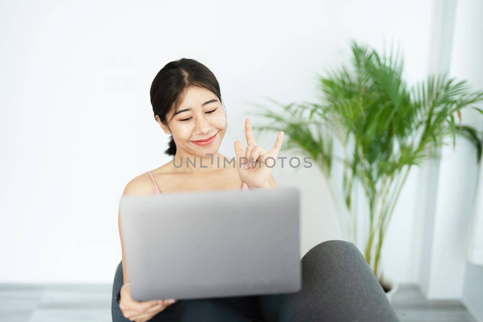 stress relief, muscle relaxation, breathing exercises, exercise, meditation, portrait of Young Asian woman relaxing her body from office work by practicing yoga by watching online tutorials