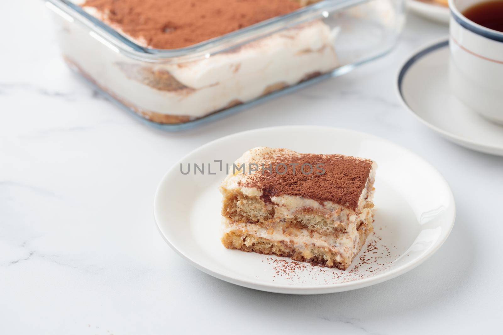 Piece of Homemade Tiramisu cake dessert by Gudzar