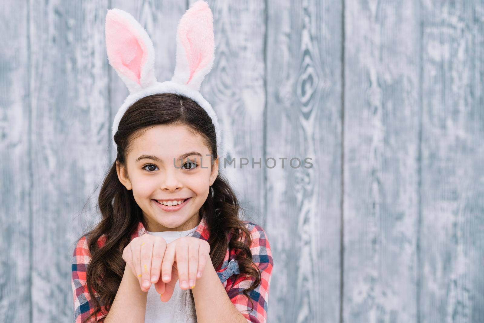 close up girl posing like bunny against wooden gray background by Zahard