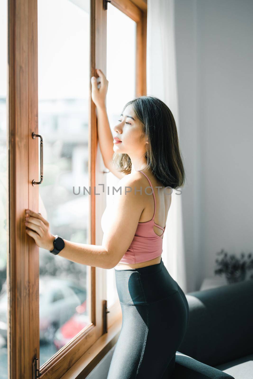 stress relief, muscle relaxation, breathing exercises, exercise, meditation, portrait of Young Asian woman relaxing her body from office work by practicing yoga by watching online tutorials. by Manastrong