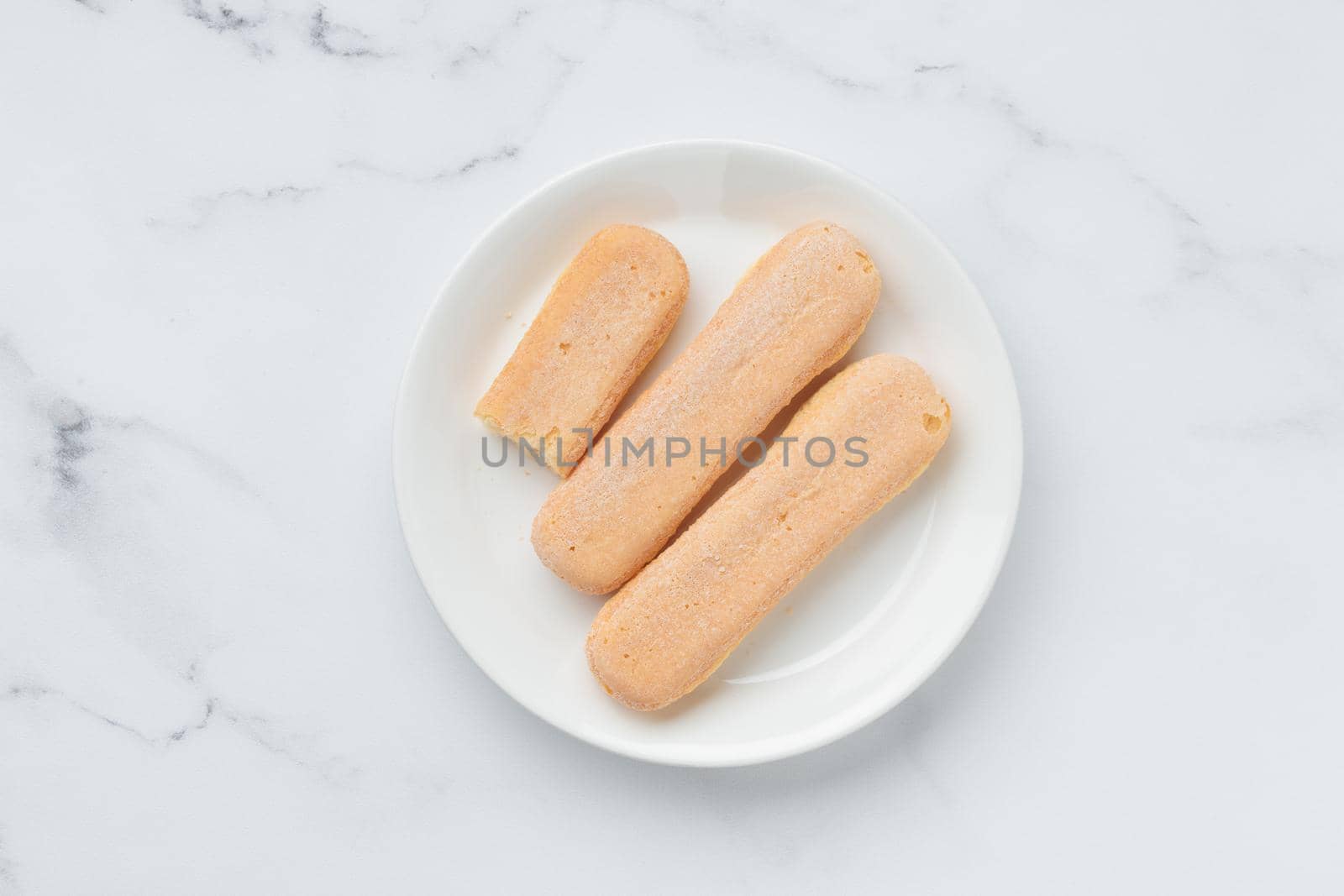 Italian cookie savoiardi. Sweet biscuits. Sponge cookies tiramisu isolated on white background. Copy Space
