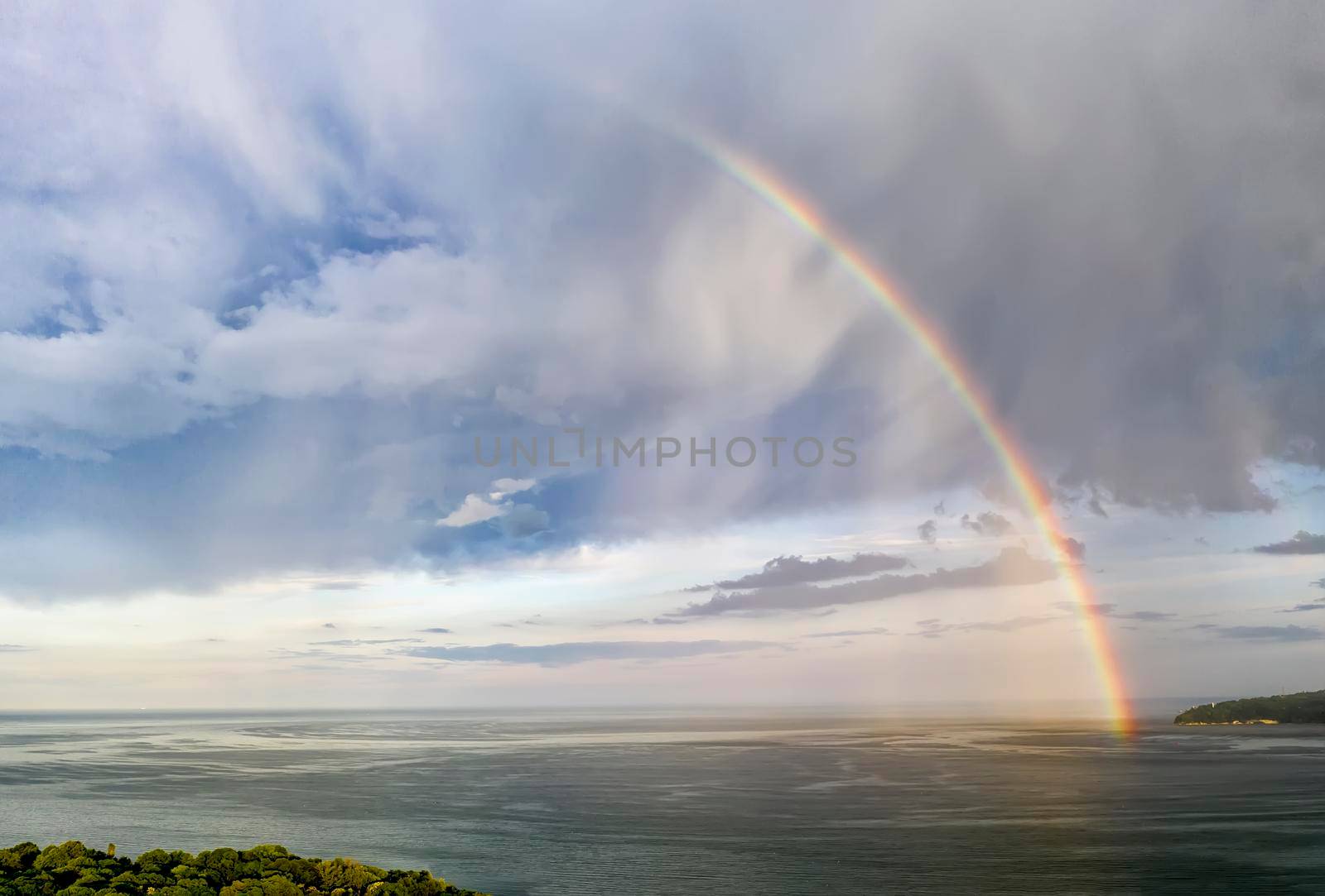 Stunning big rainbow after the rain over the sea