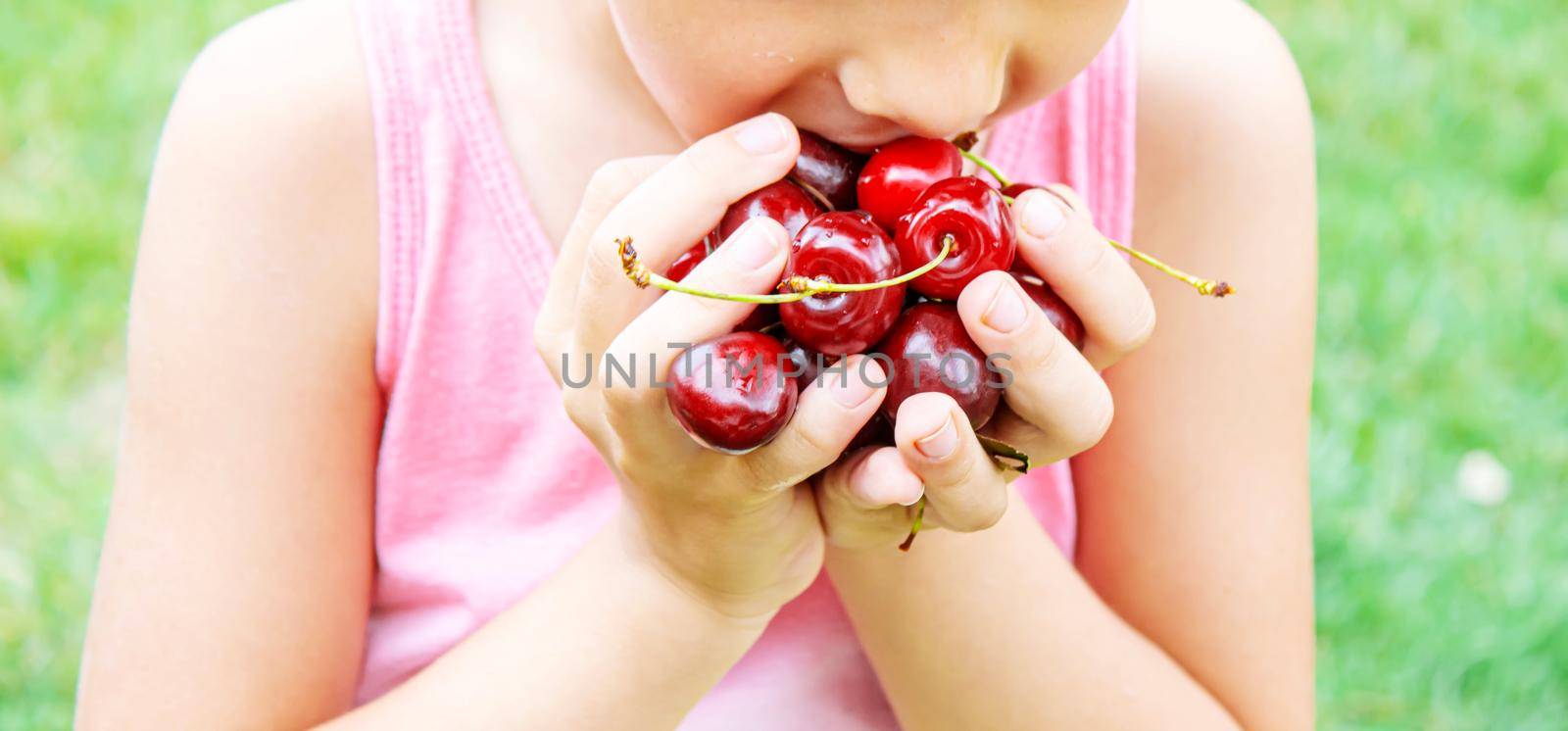 grandparents feed the child with cherries.selective focus.nature