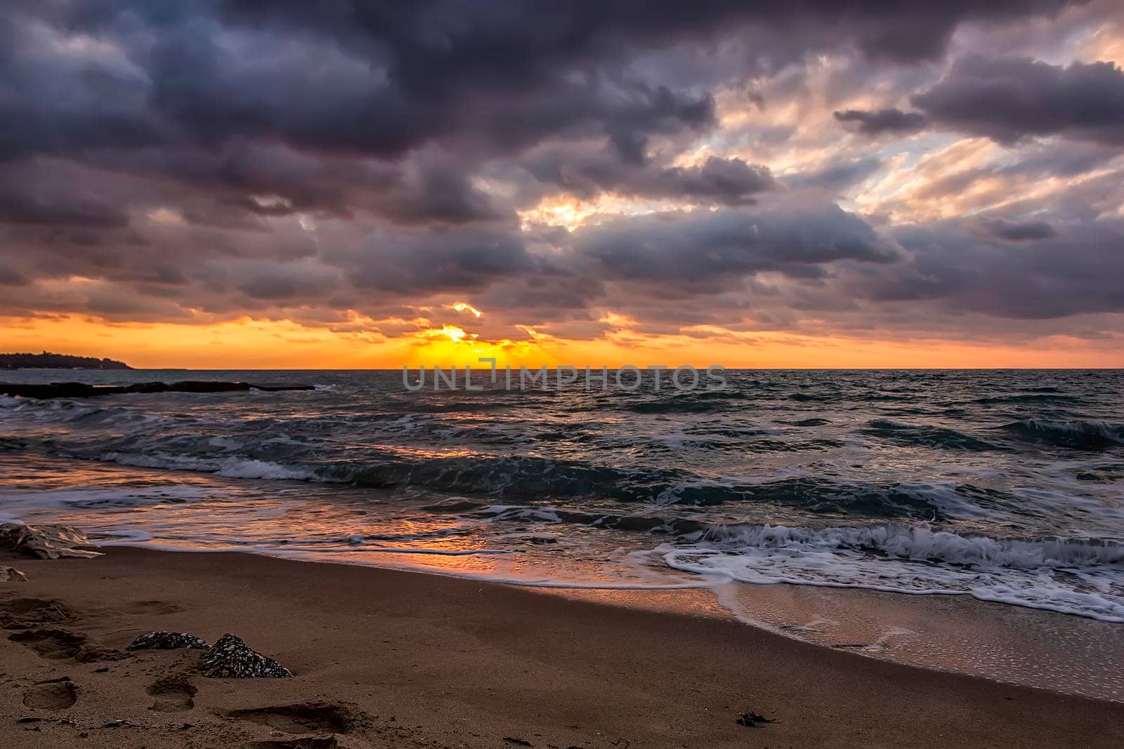 Amazing sun rays between stormy clouds and the sea. 