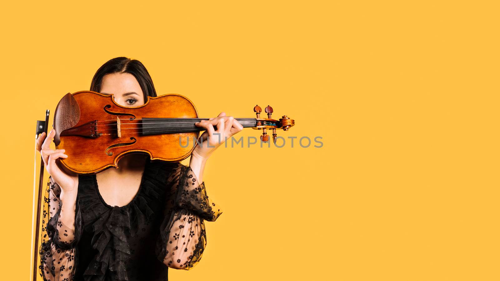 girl hiding violin