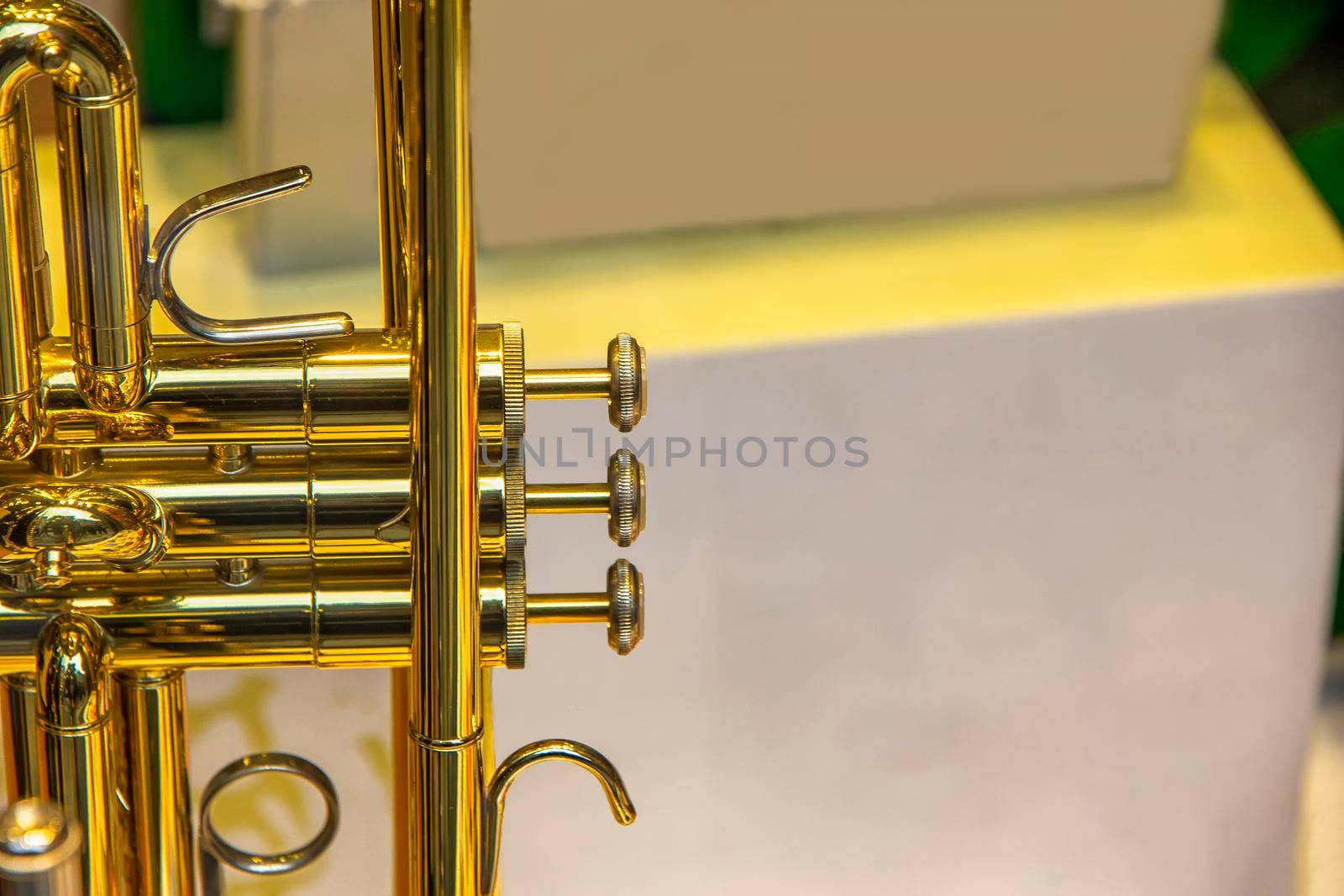 A part of the stunning golden trumpet with brass details. Close up of trumpet finger buttons valves