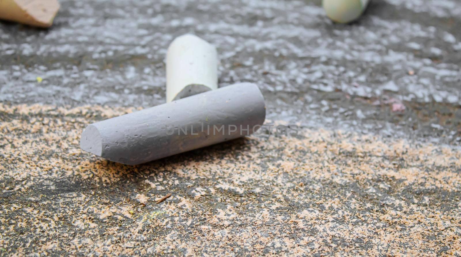 Three colored stripes, drawing with chalk on asphalt. Selective focus.arts
