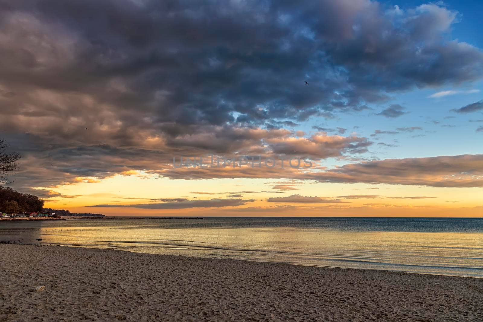 Beautiful colorful clouds over the sea. Amazing sky after sunset.