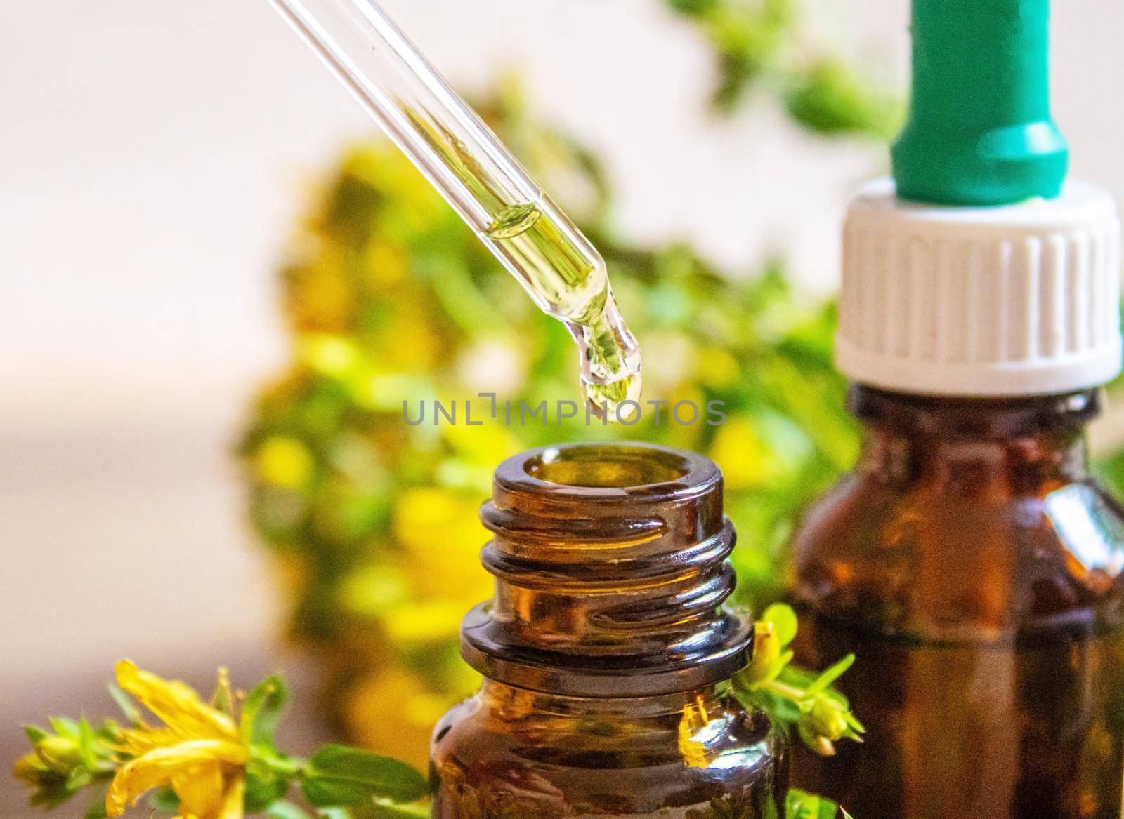 extract St. John's wort in a small jar. Selective focus. by mila1784