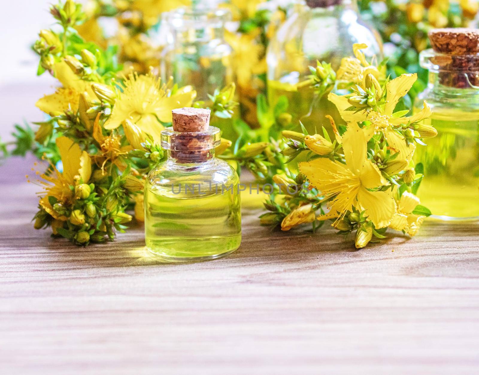 extract St. John's wort in a small jar. Selective focus. by mila1784