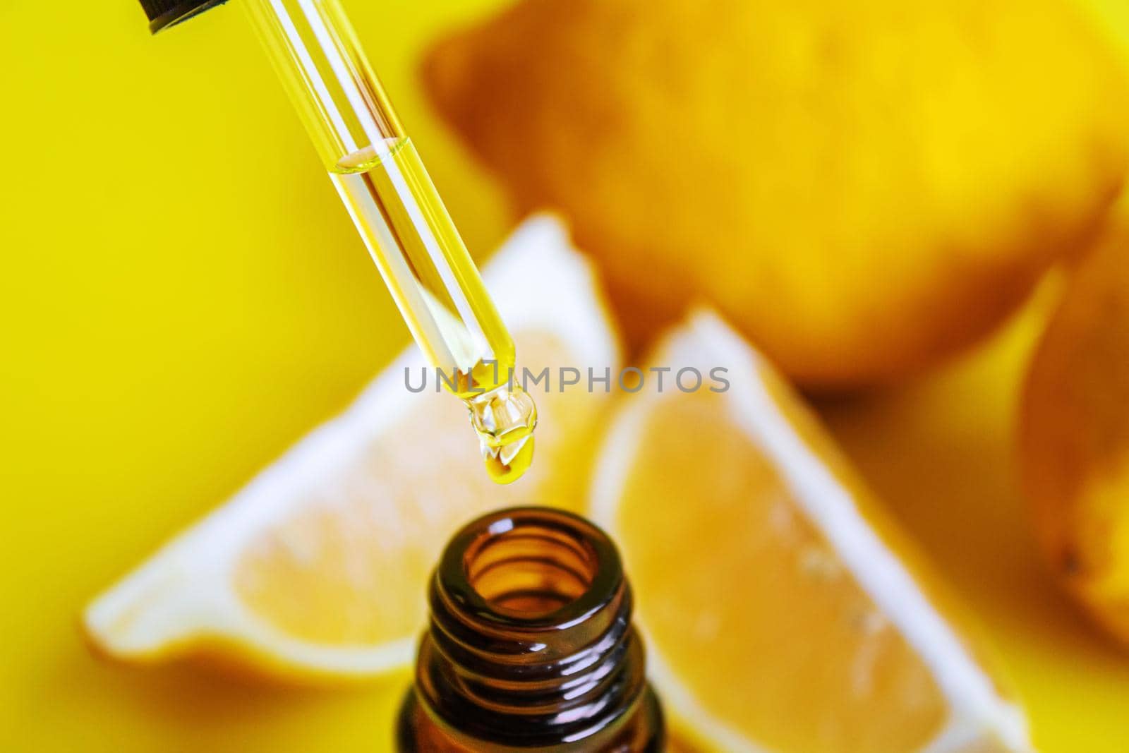 lemon essential oil on a yellow background. Selective focus.nature