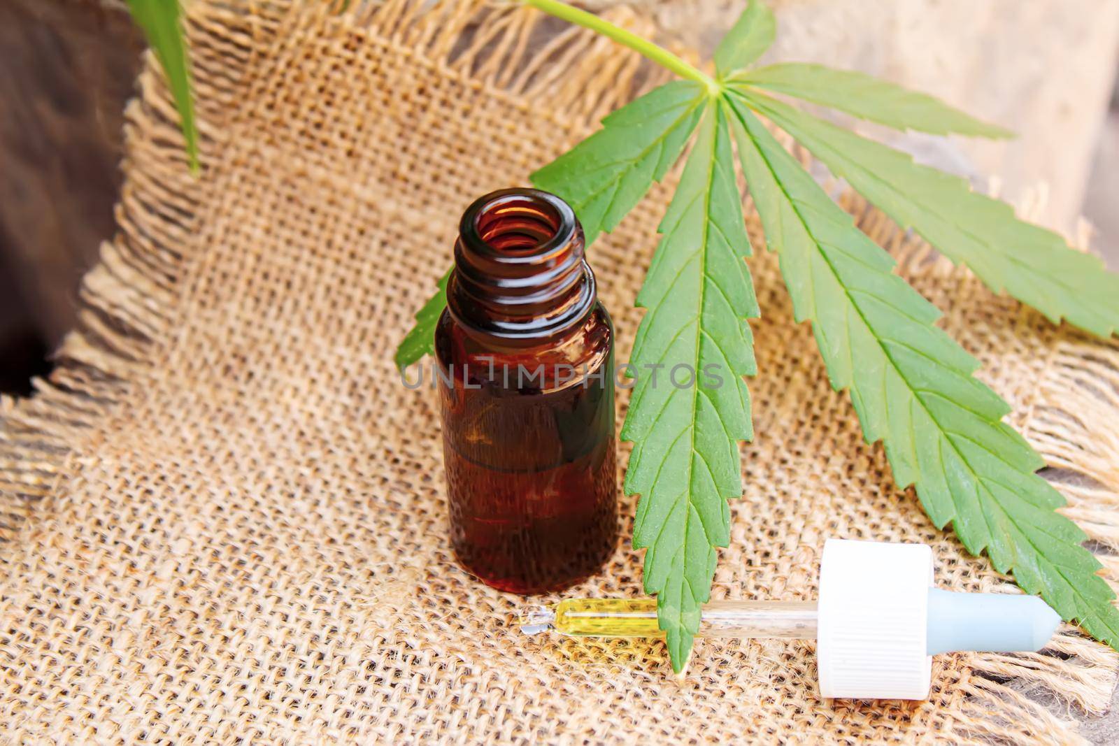Cannabis essential oil in a small bottle. Selective focus. nature.
