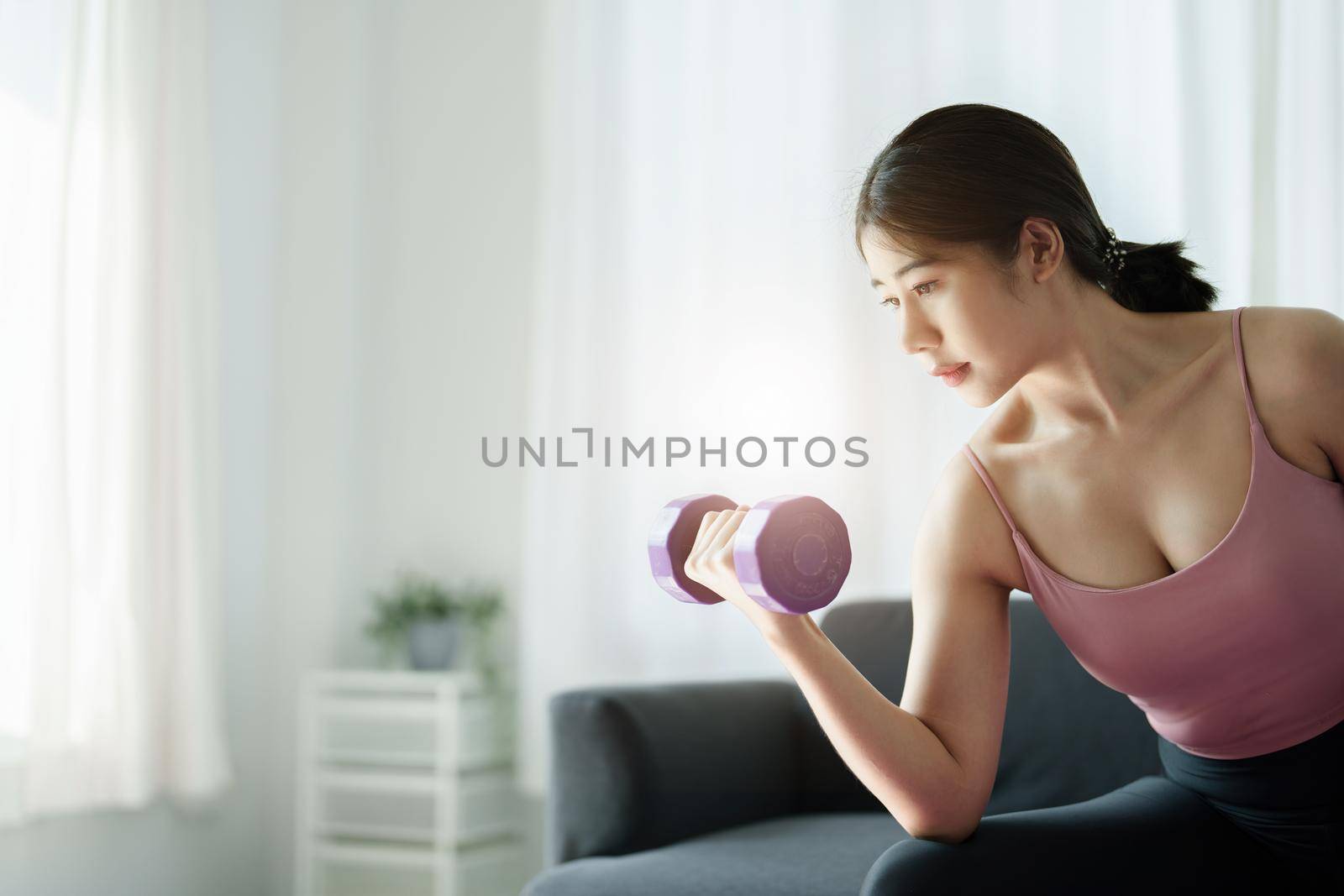 stress relief, , breathing exercises, meditation, portrait of Asian healthy woman lifting weights to strengthen her muscles after work. by Manastrong
