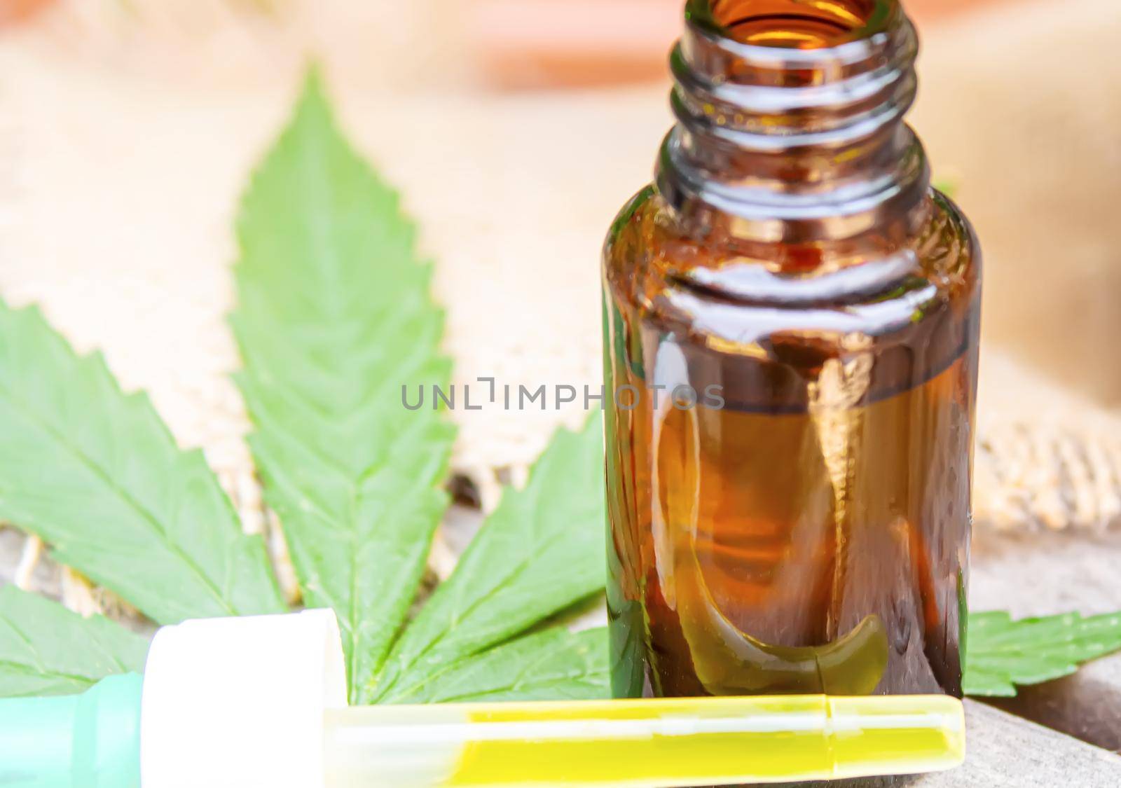 Cannabis essential oil in a small bottle. Selective focus. by mila1784