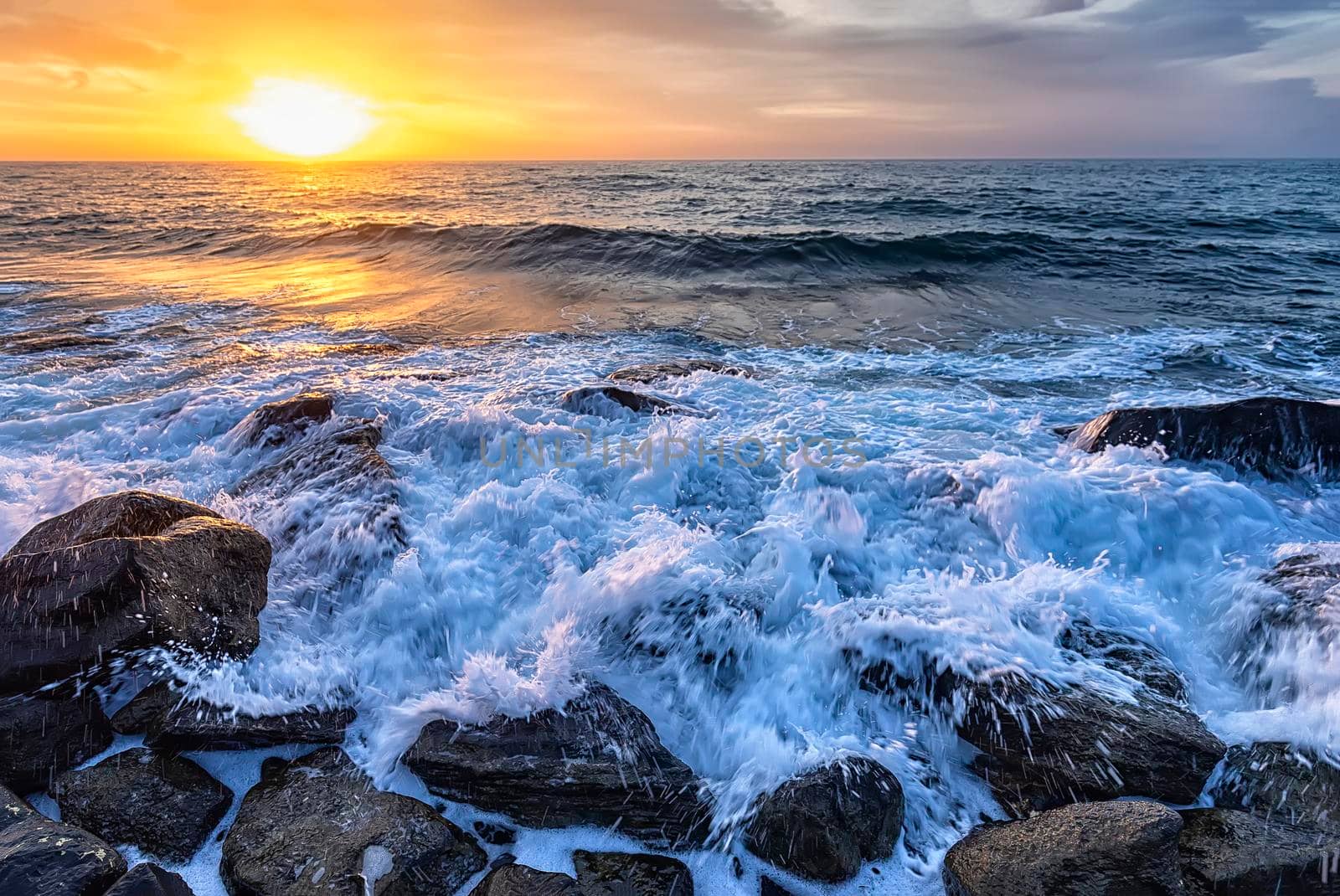 The stunning seascape with the colorful sunrise sky at the rocky coastline of the Black Sea