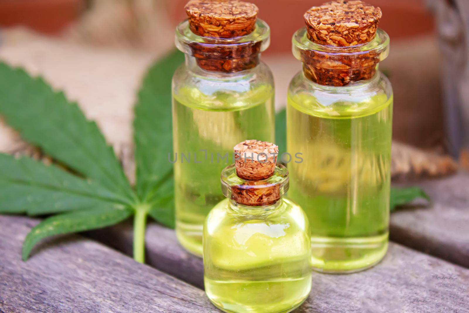 Cannabis essential oil in a small bottle. Selective focus. by mila1784