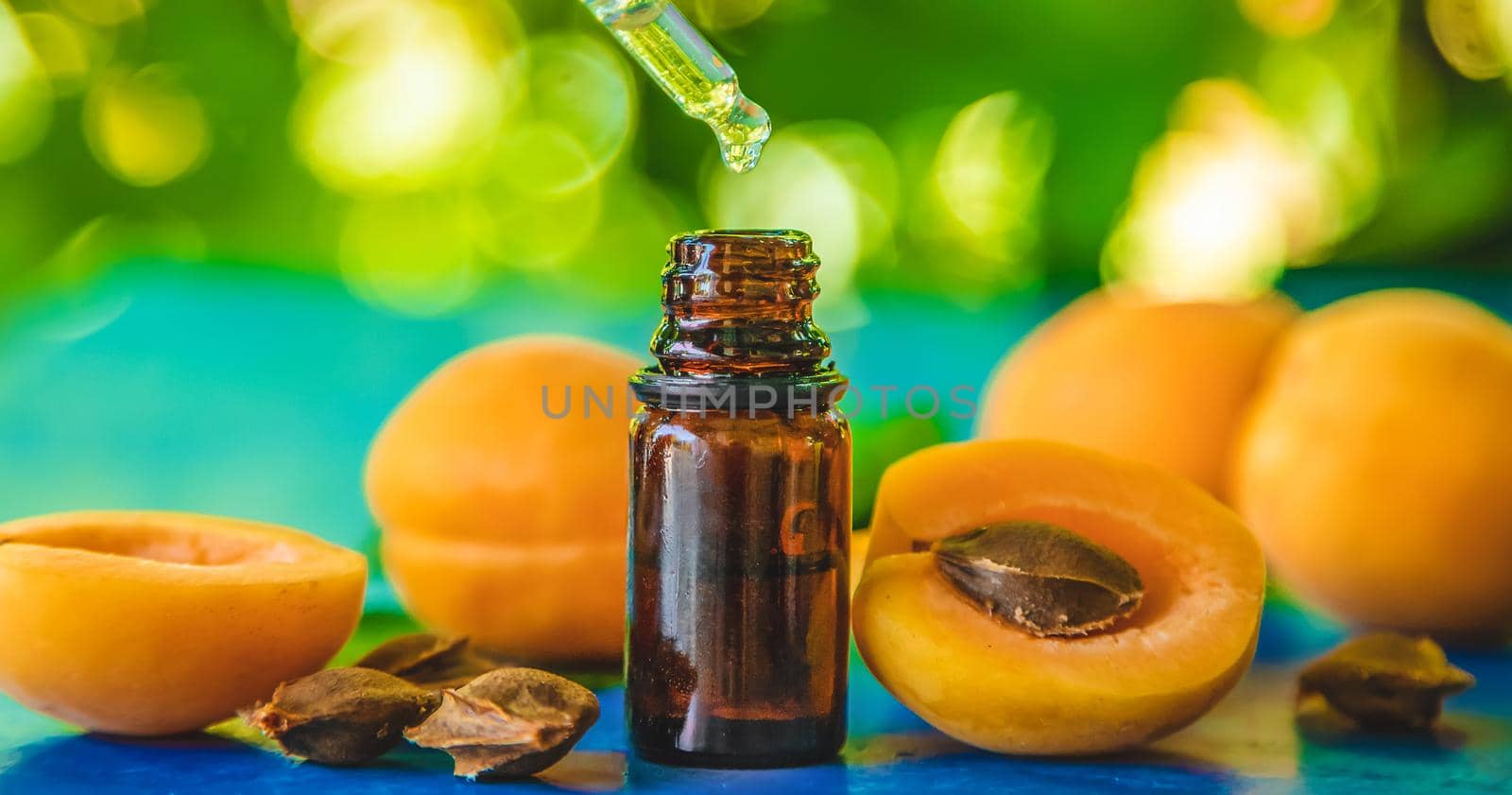 Apricot kernel oil in a bottle. Selective focus. Nature.