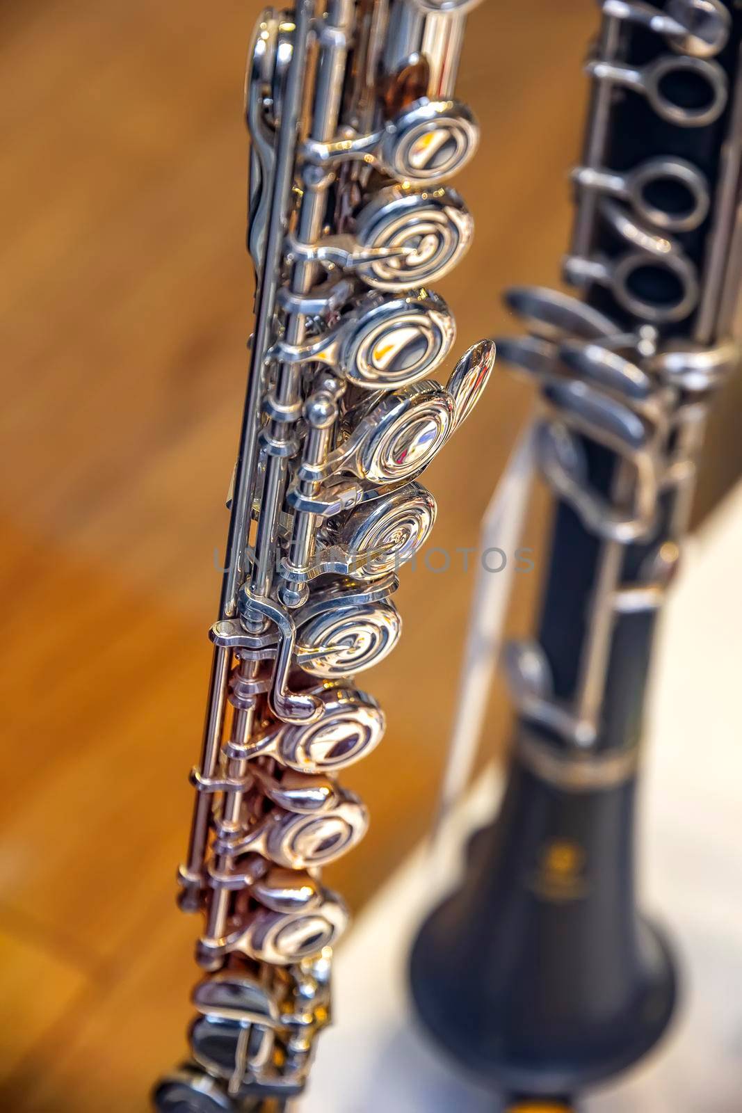 A part of the classical wind instrument flute with brass details. Close up of trumpet finger buttons valves by EdVal