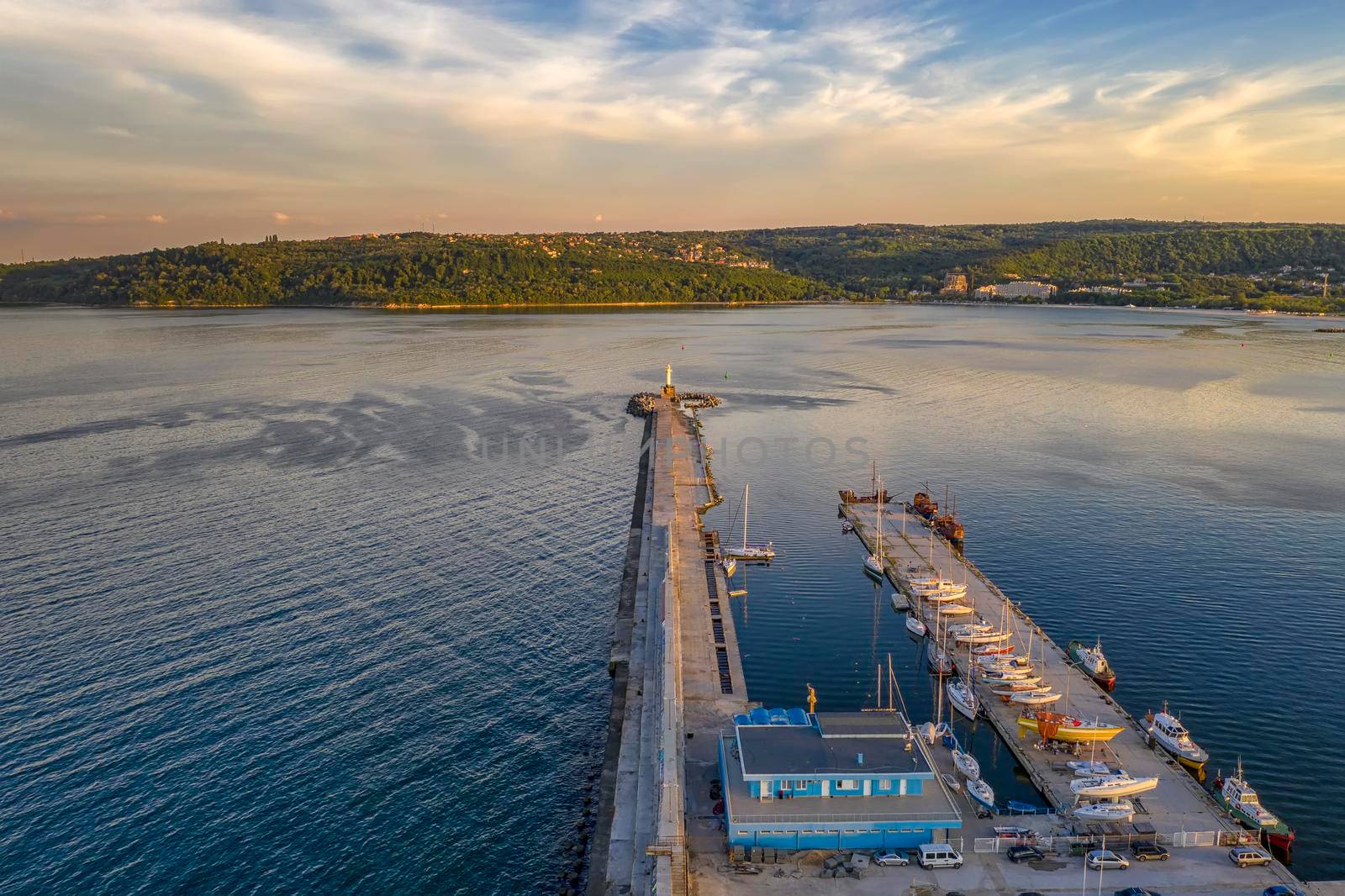 Aerial view of breakwater yachts, and boats at stunning sunset in the harbor. Black sea, Varna, Bulgaria 