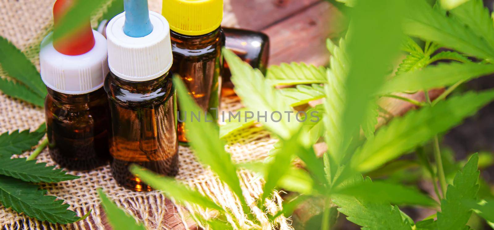 Cannabis extract essential oil in a small bottle. Selective focus. by mila1784