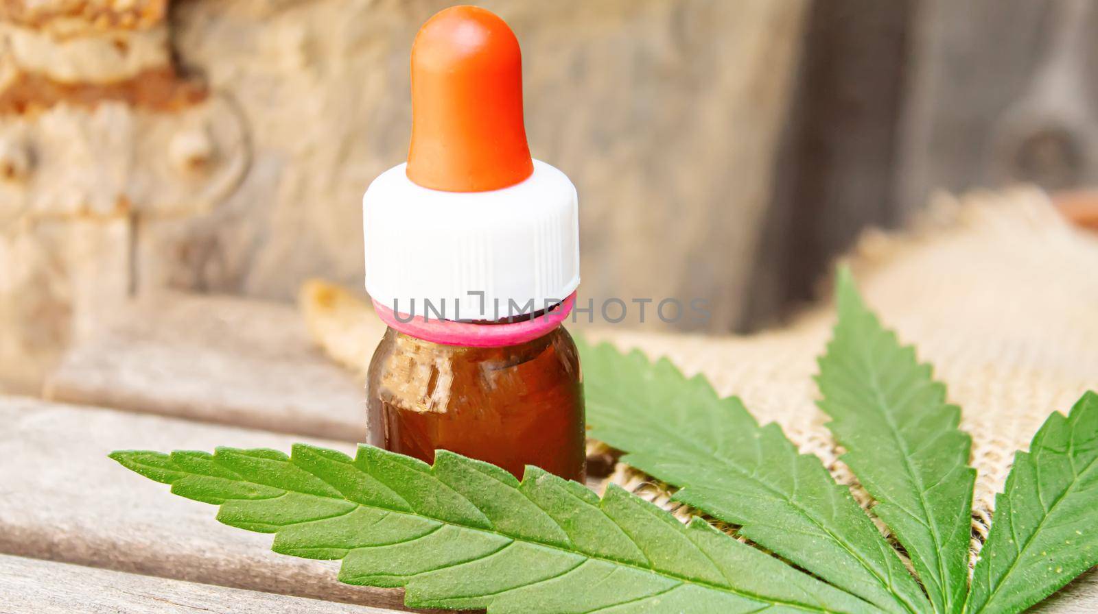 Cannabis essential oil in a small bottle. Selective focus. by mila1784