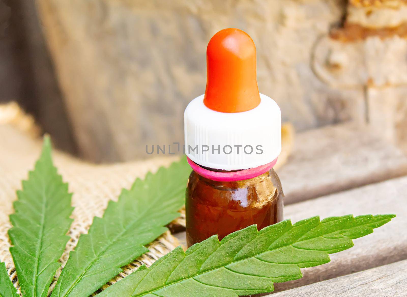 Cannabis essential oil in a small bottle. Selective focus. nature.