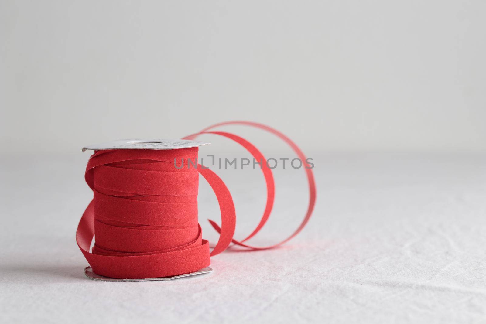 Red velvet decorative ribbon skein on white background