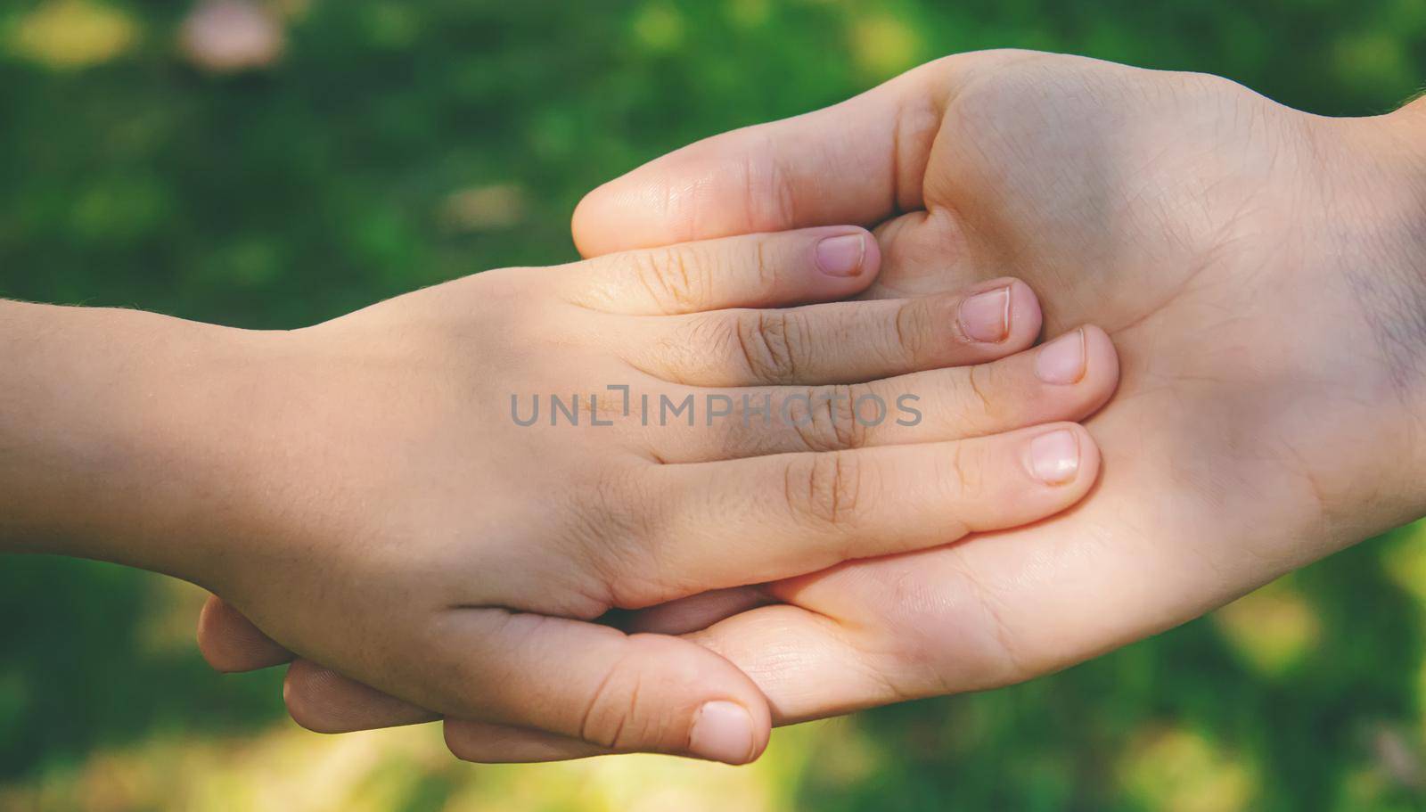mom holding baby by the hand. selective focus.people