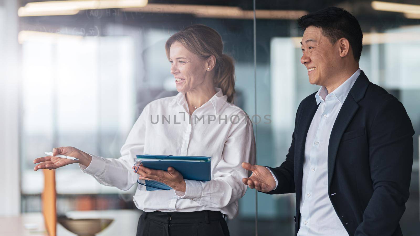 Businesswoman shows a new employee his workplace at modern office. High quality photo