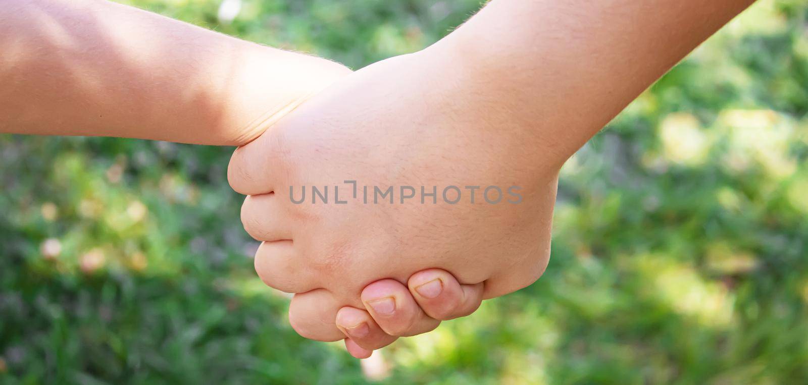 mom holding baby by the hand. selective focus by mila1784