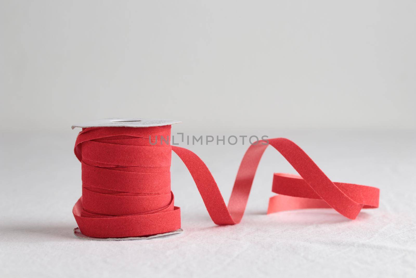 Red velvet decorative ribbon skein on white background