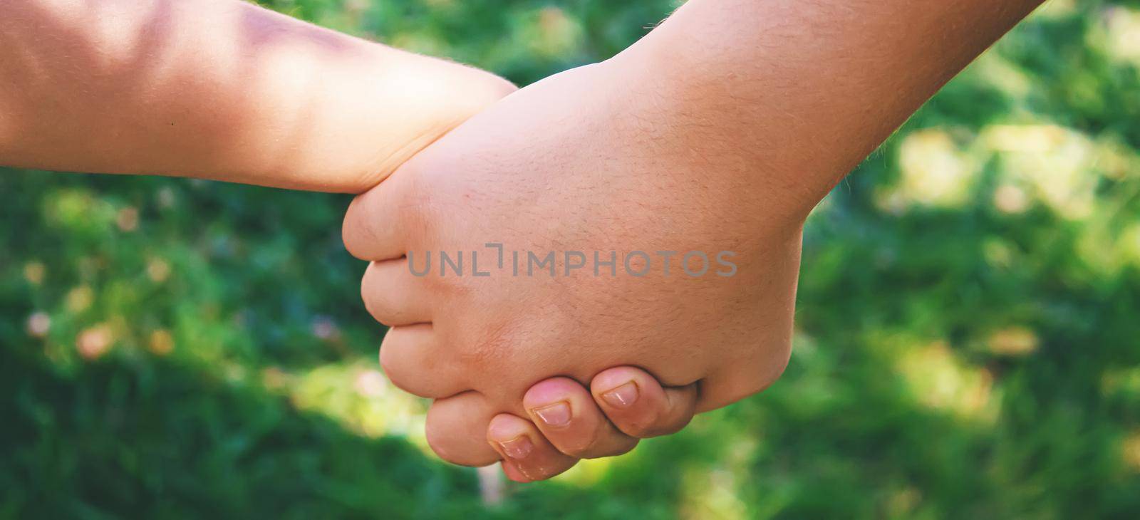 mom holding baby by the hand. selective focus by mila1784