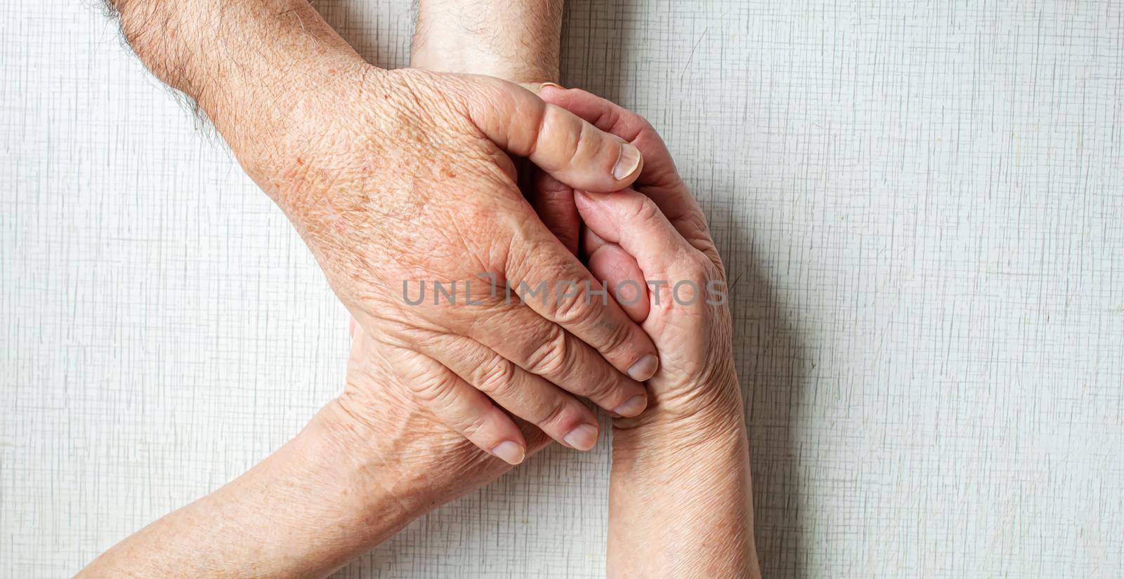 old people holding each hand. selective focus.people