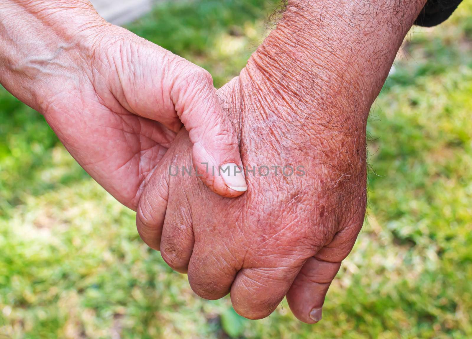 old man holding child's hands. selective focus people