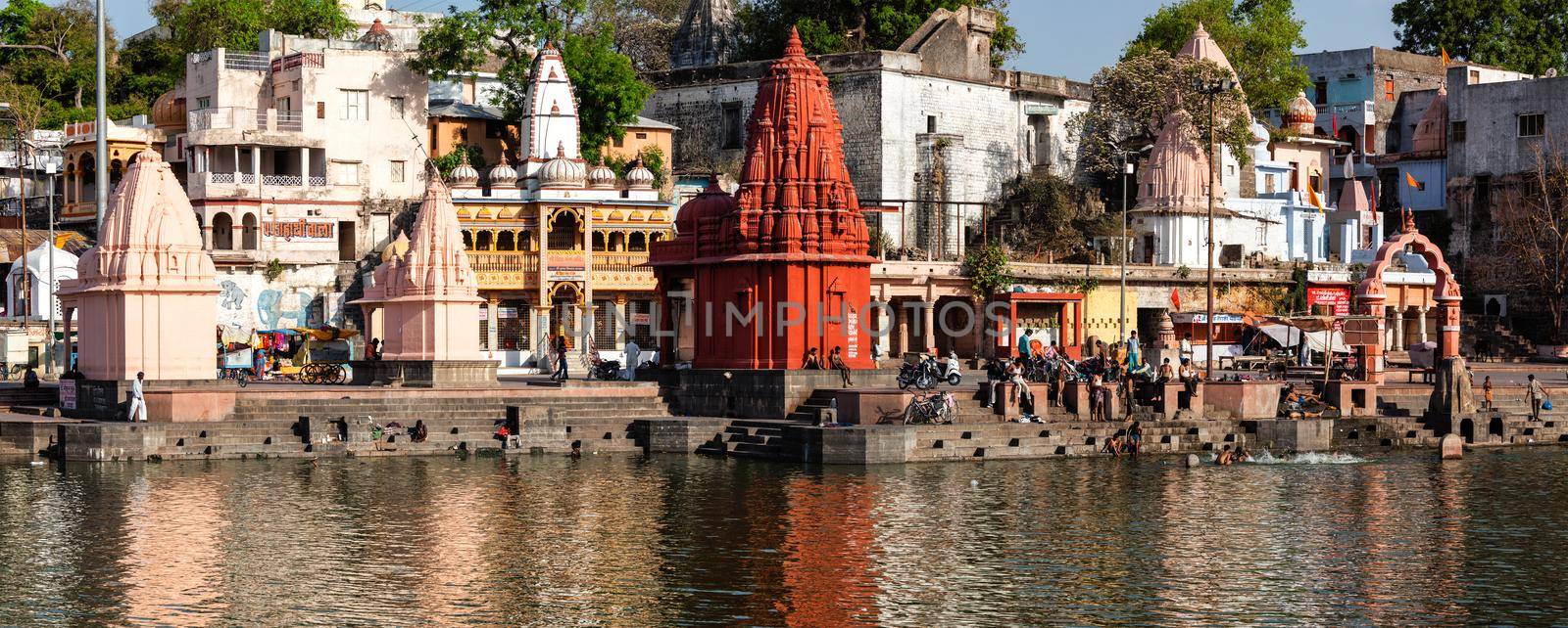 People bathing in sacred Rhipra River on ghats of the holy city of Ujjain by dimol