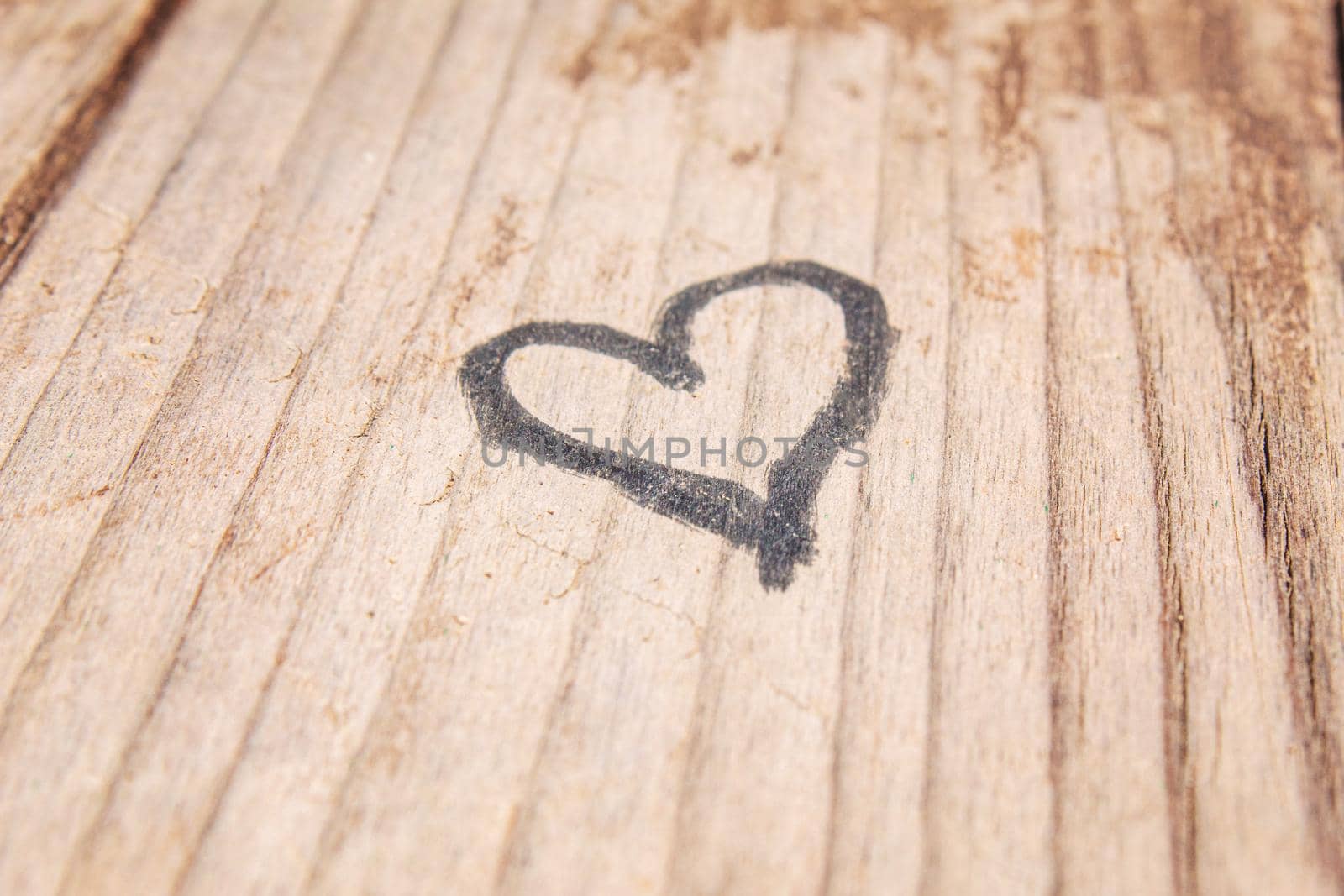 heart drawn on an old wooden background. selective focus .nature