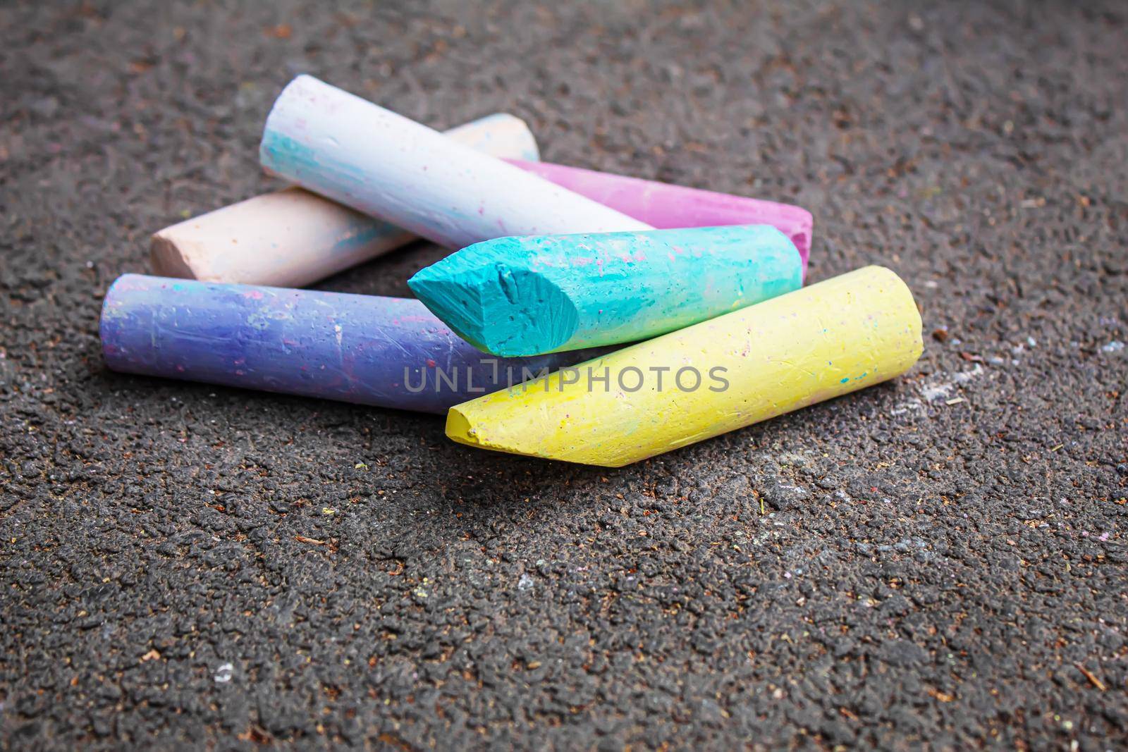 Three colored stripes, drawing with chalk on asphalt. Selective focus.arts