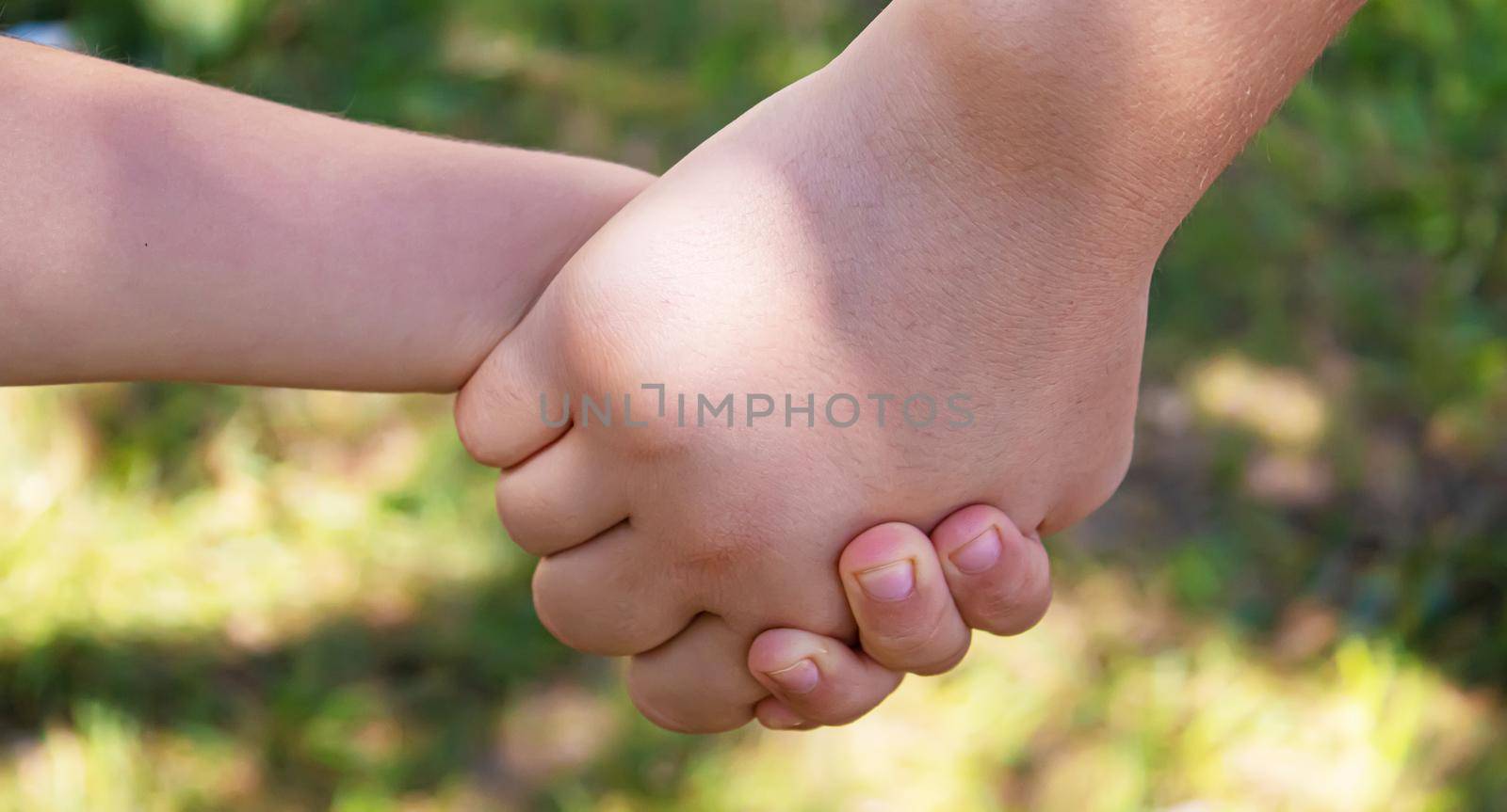 mom holding baby by the hand. selective focus.people