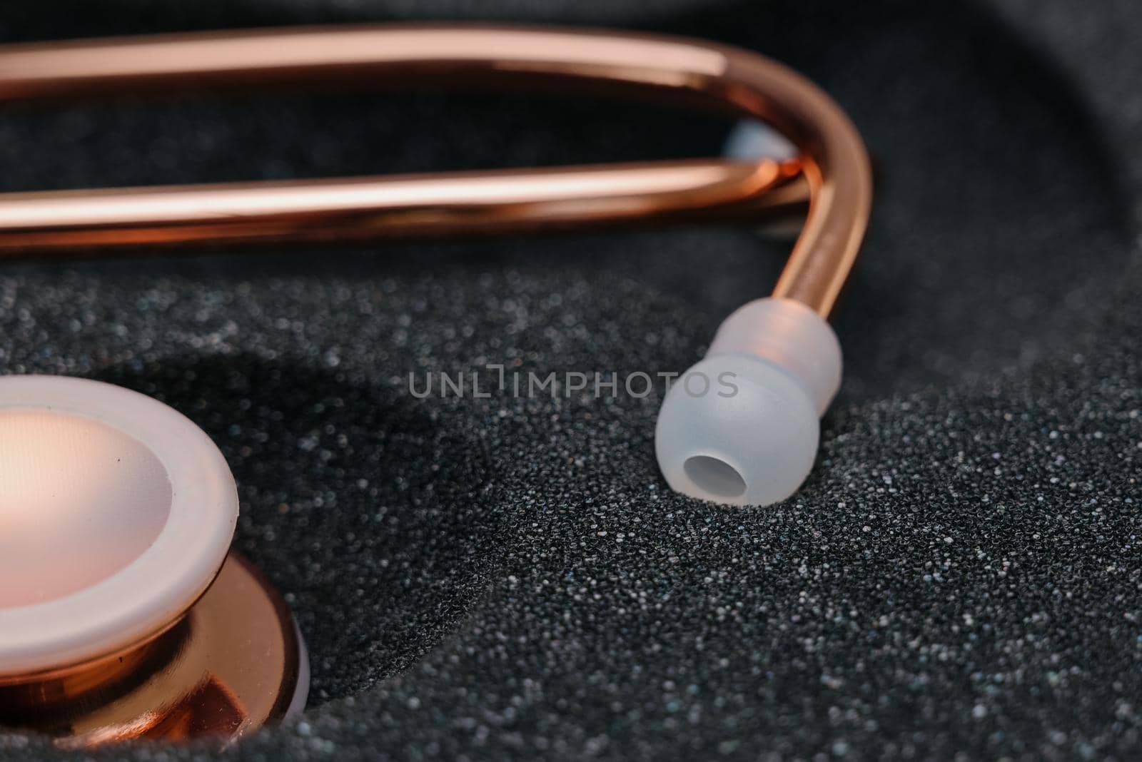 Medical stethoscope.Pink medical stethoscope.The concept of healthcare.Stethoscope on a dark background