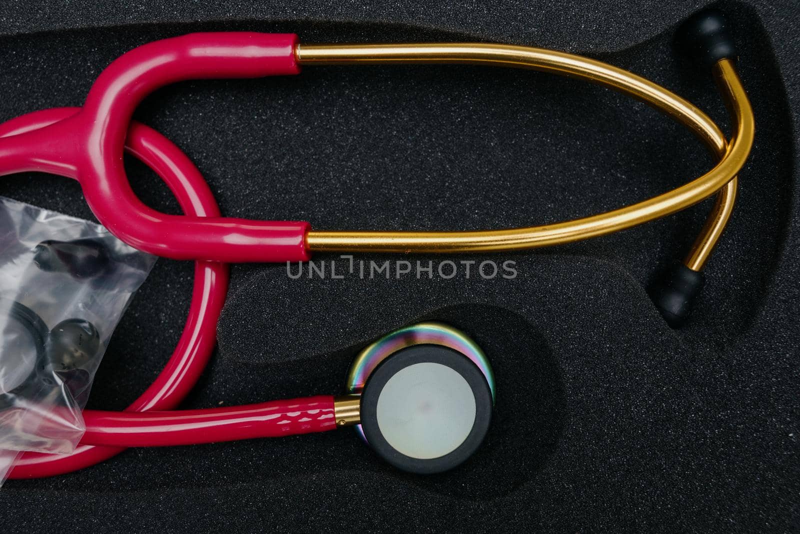 Medical stethoscope. Red medical stethoscope.The concept of healthcare.Stethoscope on a dark background
