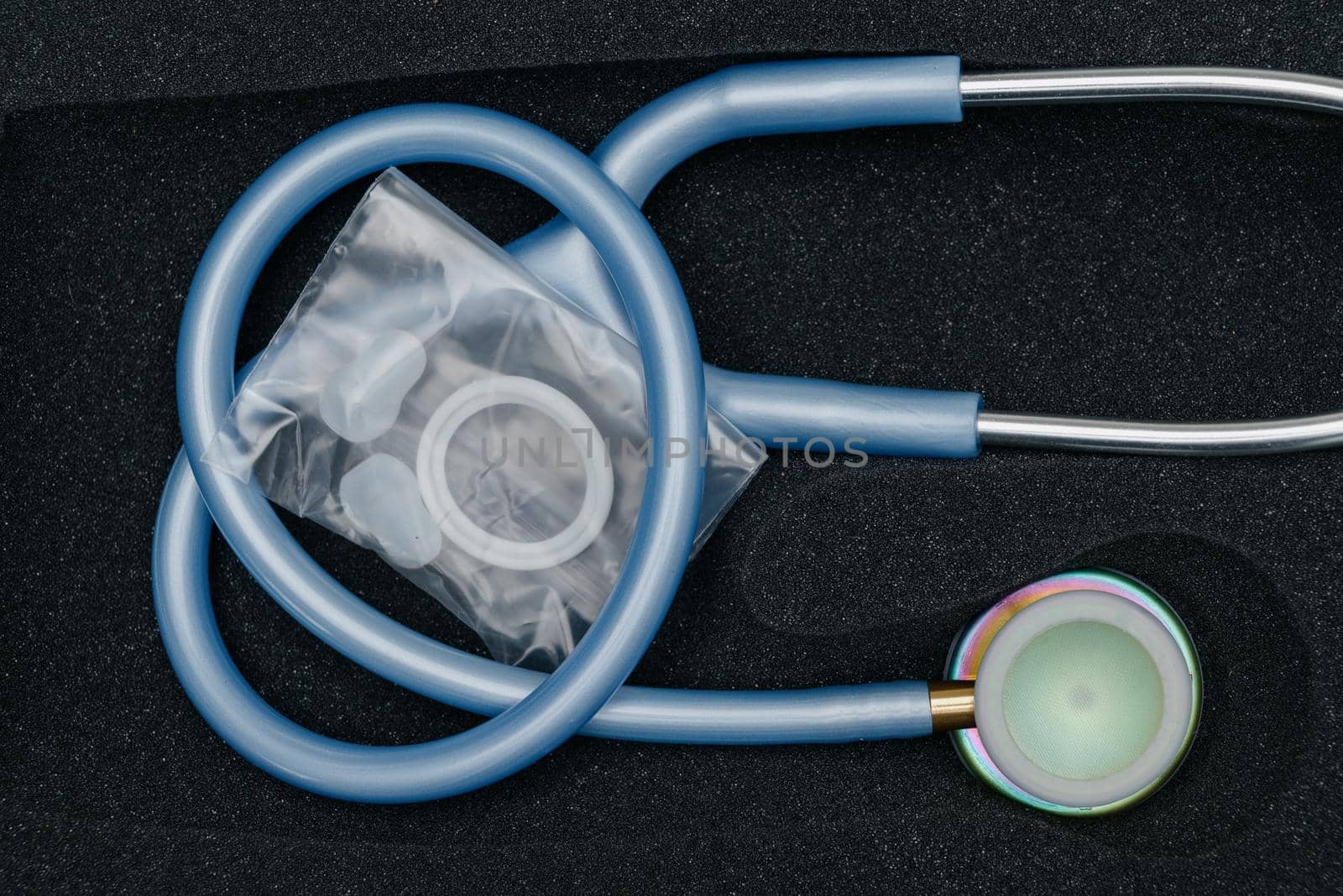 Medical stethoscope. Blue medical stethoscope.The concept of healthcare.Stethoscope on a dark background