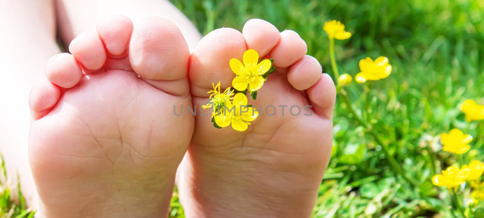 Child lying on green grass. Kid having fun outdoors in spring park. Selective focus. people